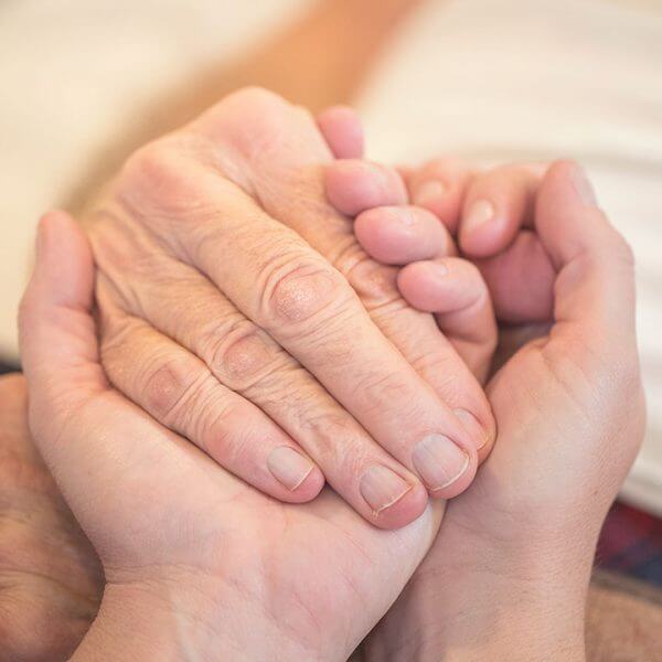 A square image of a healthcare professional providing end of life care