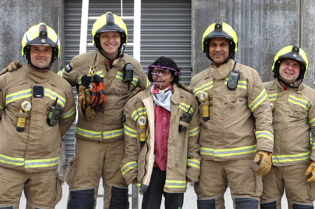 Ali with a group of firefighters