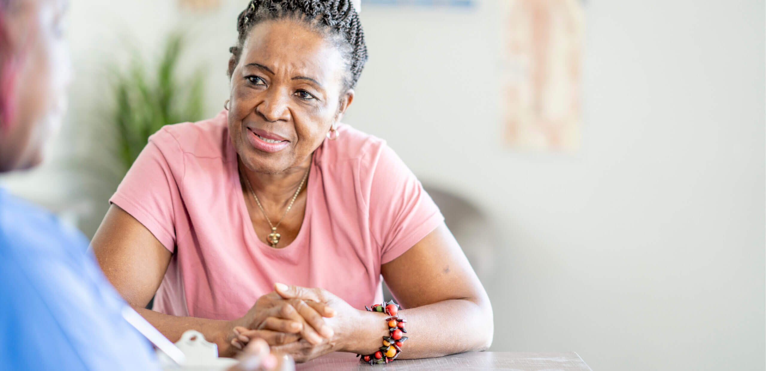 Woman talking to a health care worker at a table