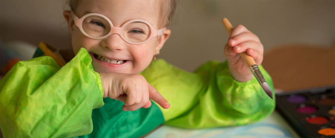 Little girl with learning difficulties painting