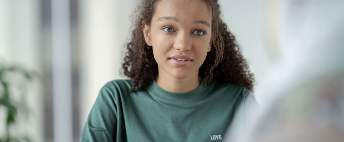 Young person talking to another person